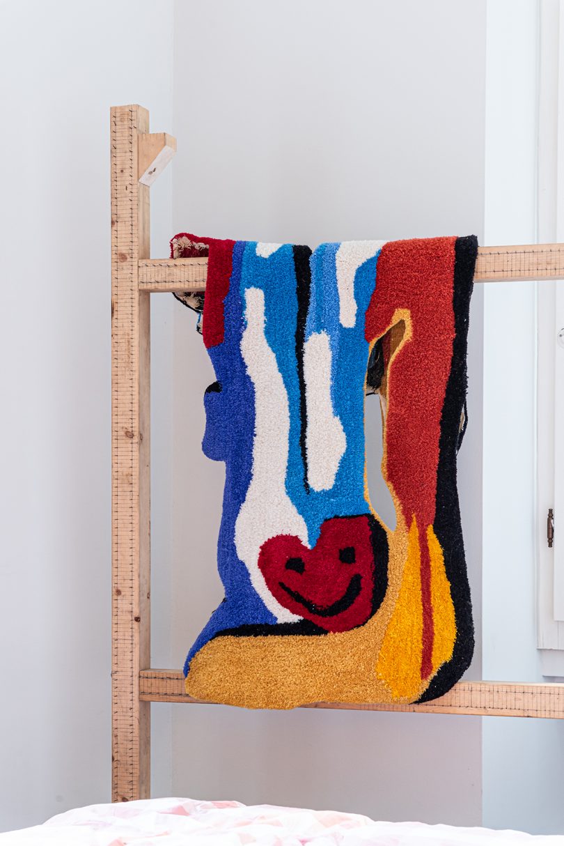 colorful textile hanging on a wooden ladder