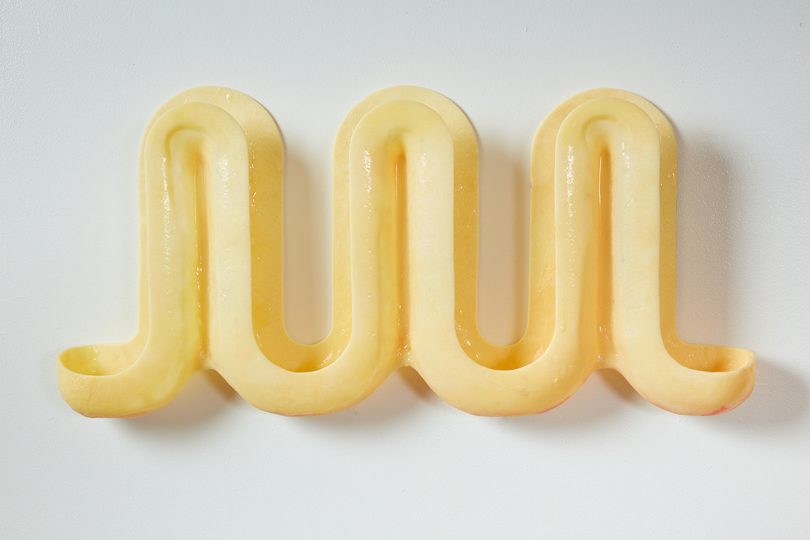 curvy light yellow wall hooks