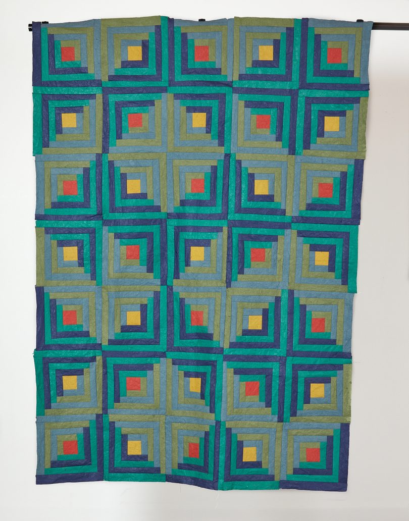 teal, yellow, and red geometric textile