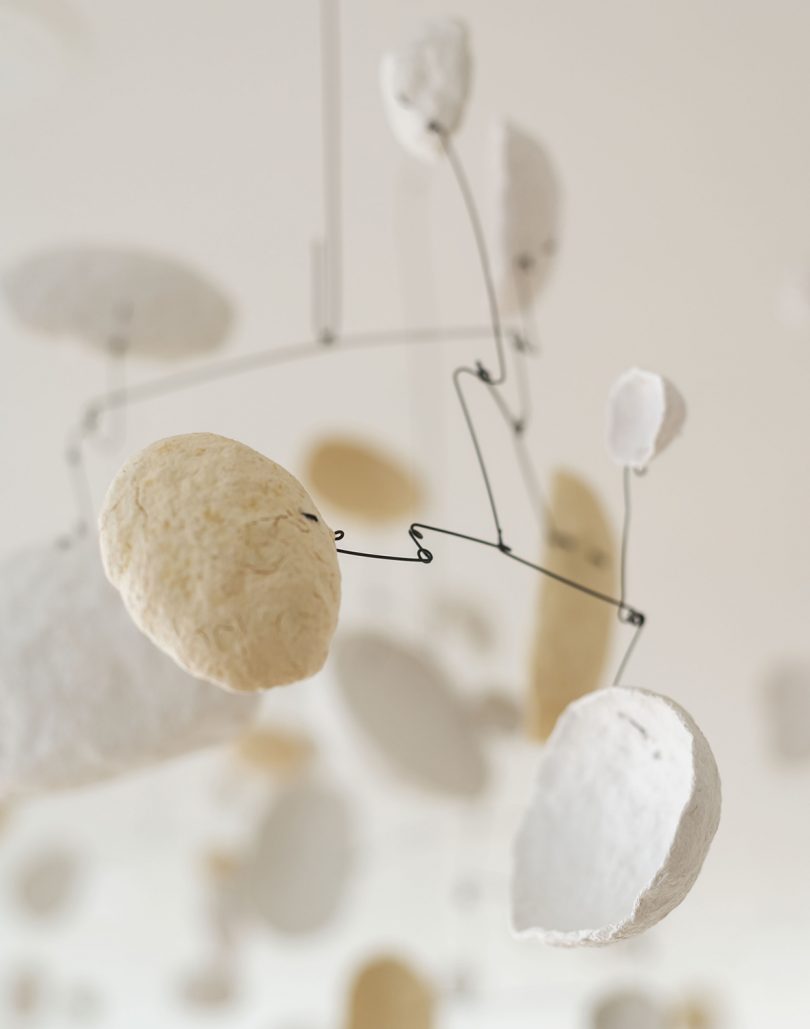 art installation of suspended white disks in white room