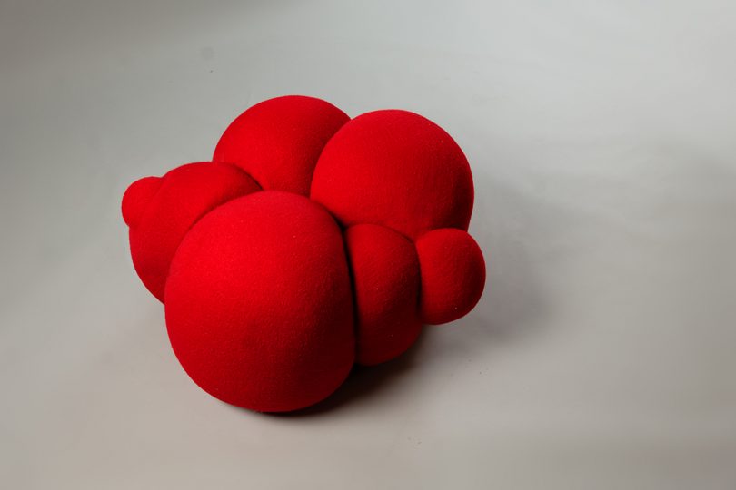 bulbous red pouffe on grey background