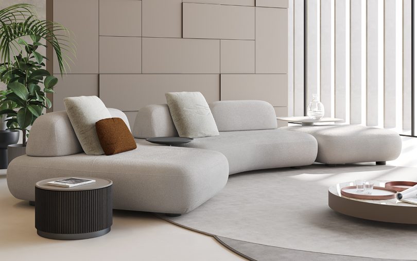 styled space with light colored curved modular sofa