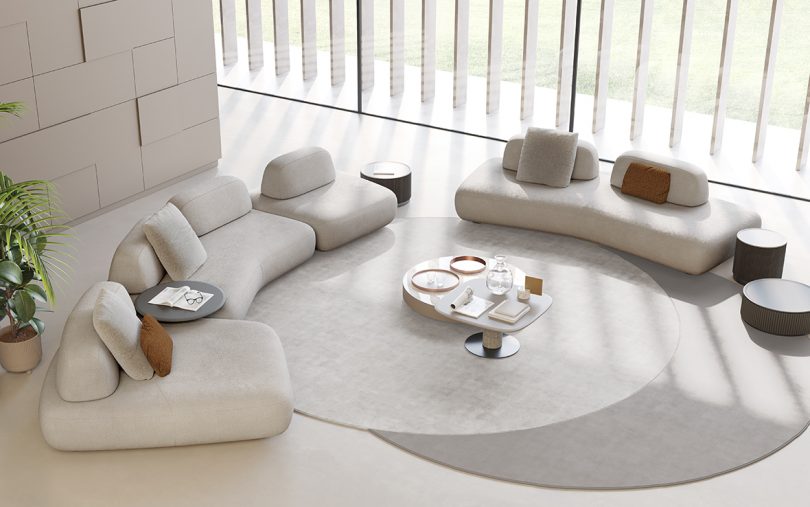 styled space with light colored curved modular sofas