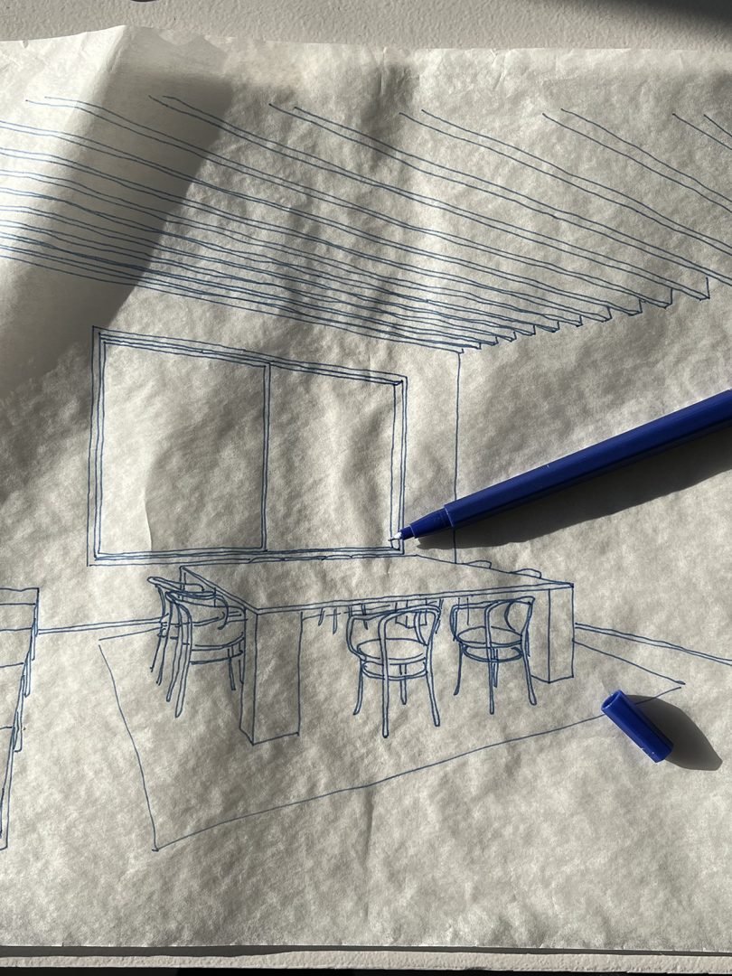 wrinkled paper with a sketch of a dining space