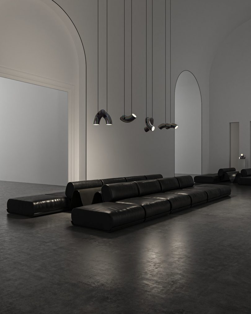 black hyphen-shaped pendant lighting in a styled space