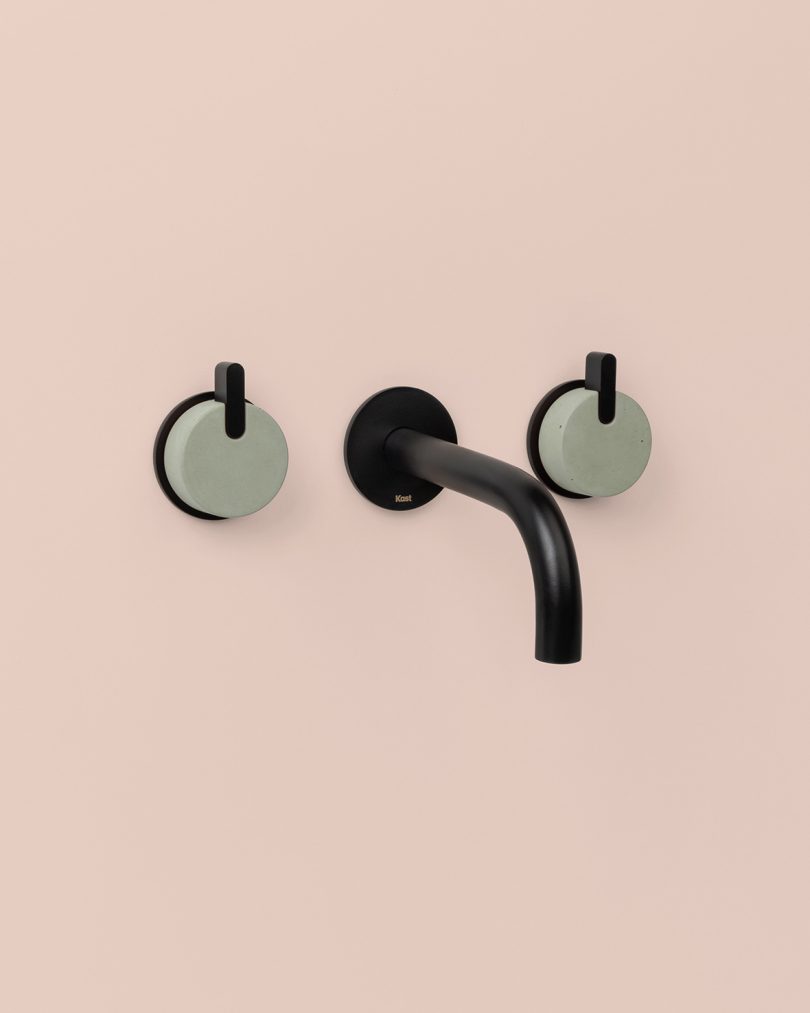 matte black and dark green mounted tap on light pink background