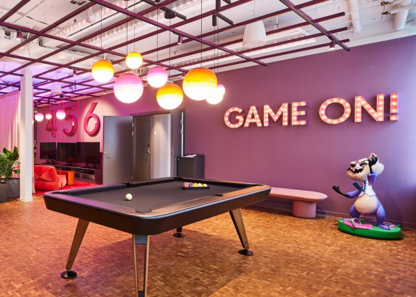 modern office interior with purple walls and pool table