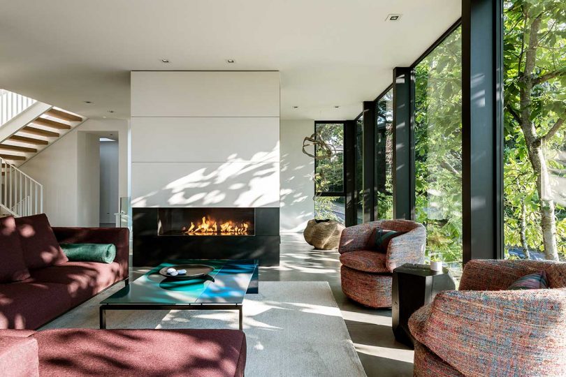 modern living room with fireplace and maroon home furnishings