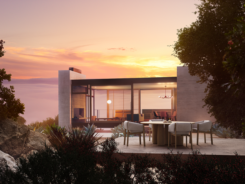 modern home overlooking large body of water at sunset