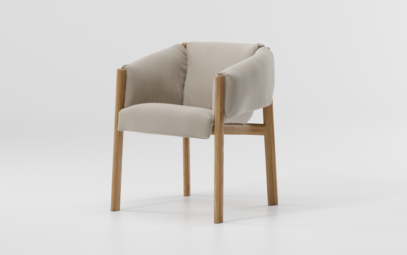 neutral colored upholstered armchair on white background