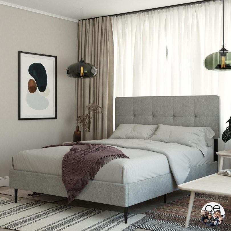 light grey upholstered bed in styled interior space