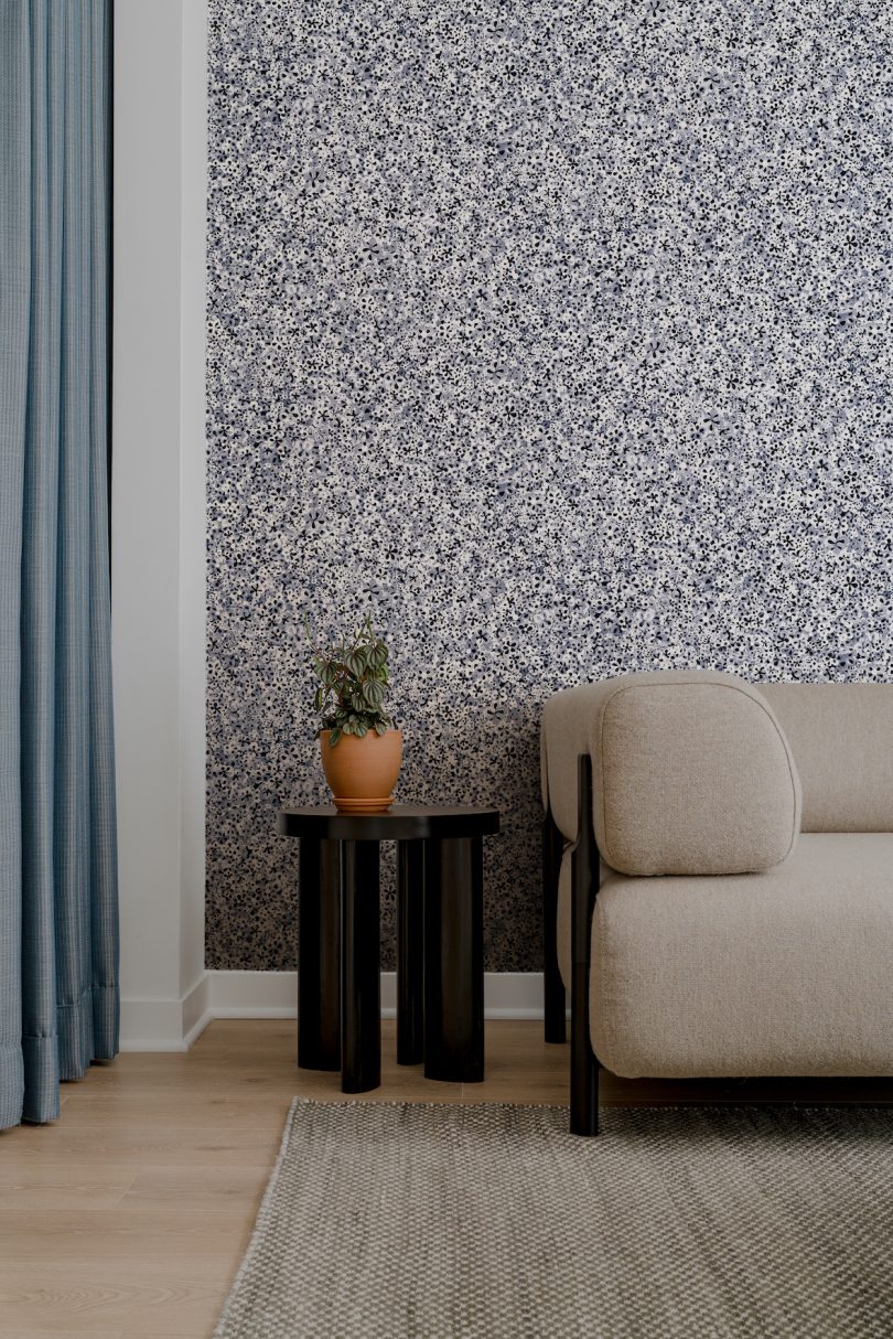 Interior view of living room with new Backdrop black, blue, and white floral wallpaper