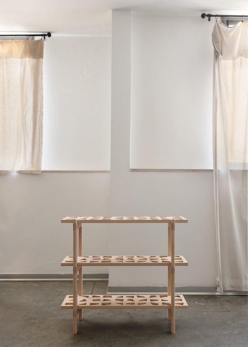 bookshelf with three shelves and intricate wood details