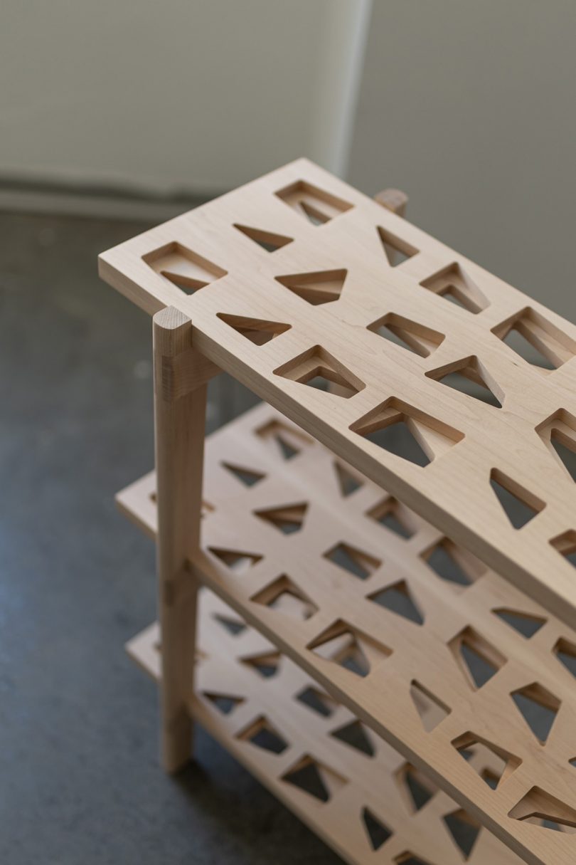 bookshelf with three shelves and intricate wood details