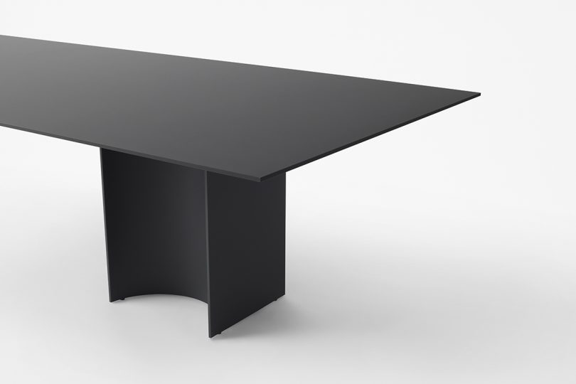 detail of rectangular black dining table on white background