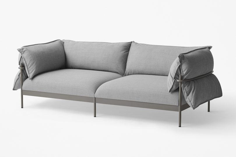 metal framed sofa covered in light grey cushions