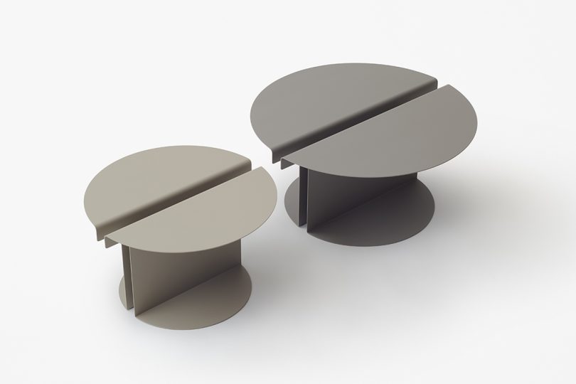 two round grey tables on white background