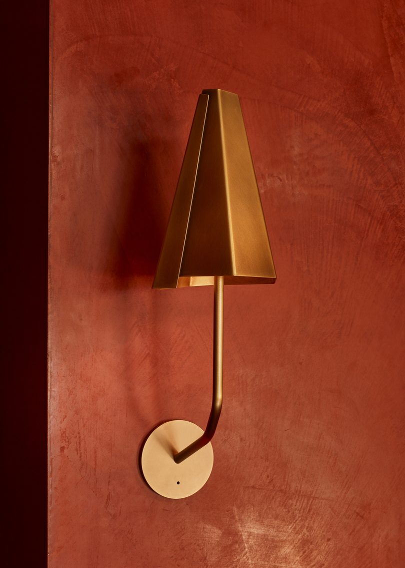 wall sconce in styled room with dark rust walls