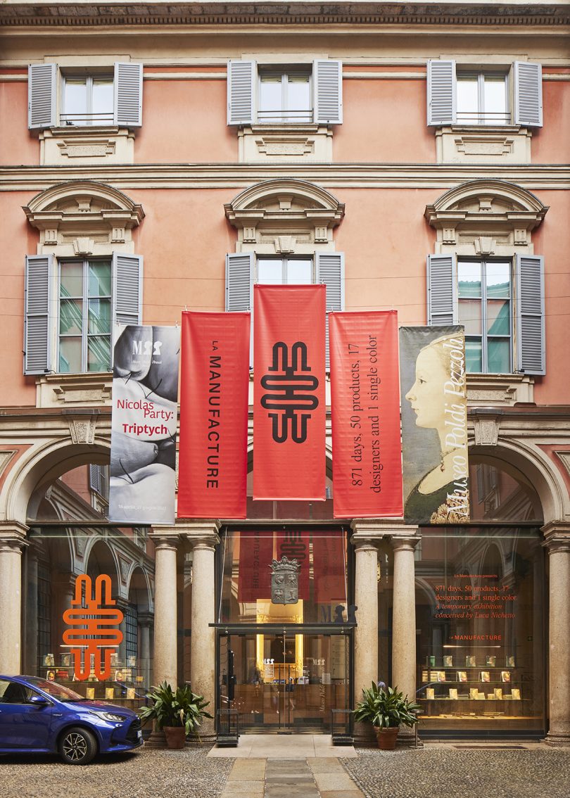exterior of gallery building with three large vermillion banners