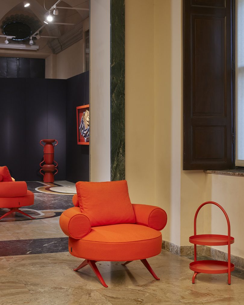 vermillion armchair and side tables in styled interior space