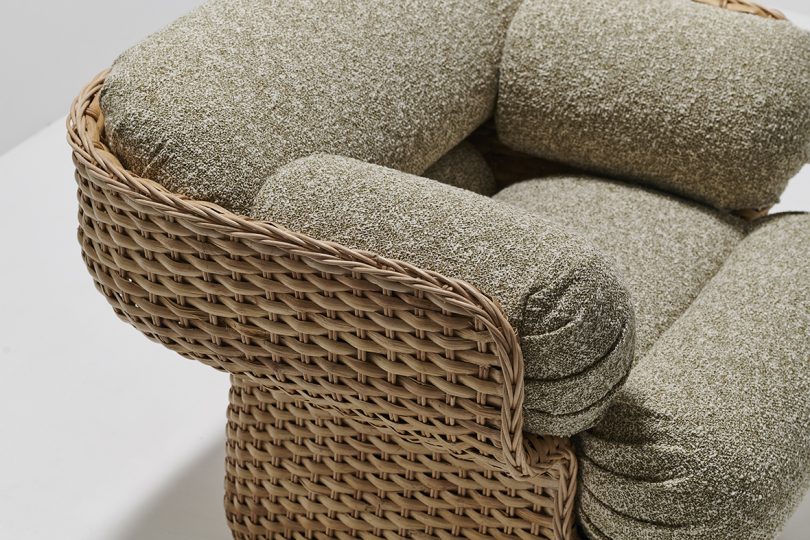 detail of modern rattan armchair in front of white wall