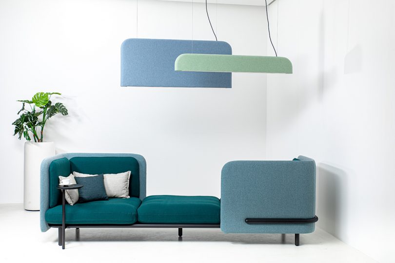 seating area with two felt hanging light fixtures in blue and green