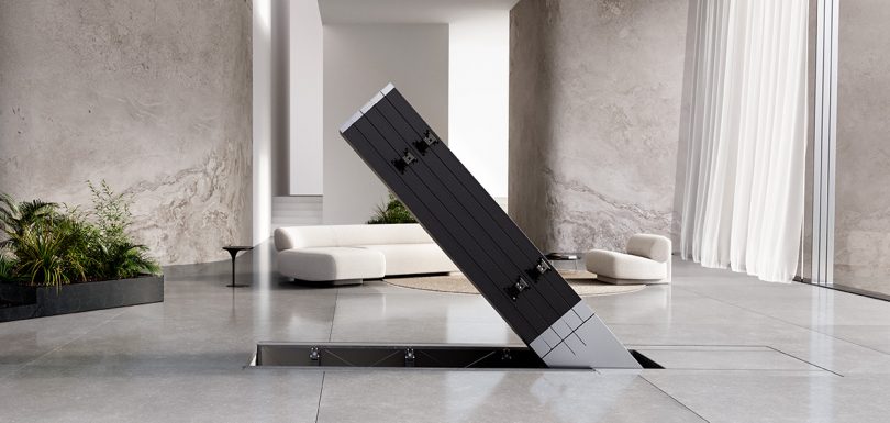 Folded television lowering into floor.