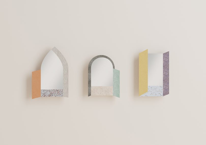 three geometric colorful mirrors hanging on a wall
