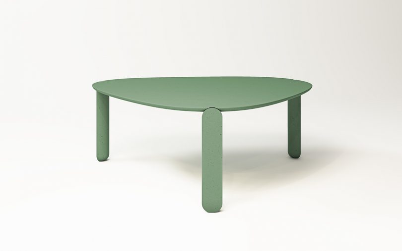 green three legged irregular-shaped table