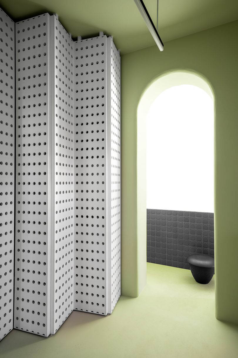 arched doorway and perforated white privacy screen