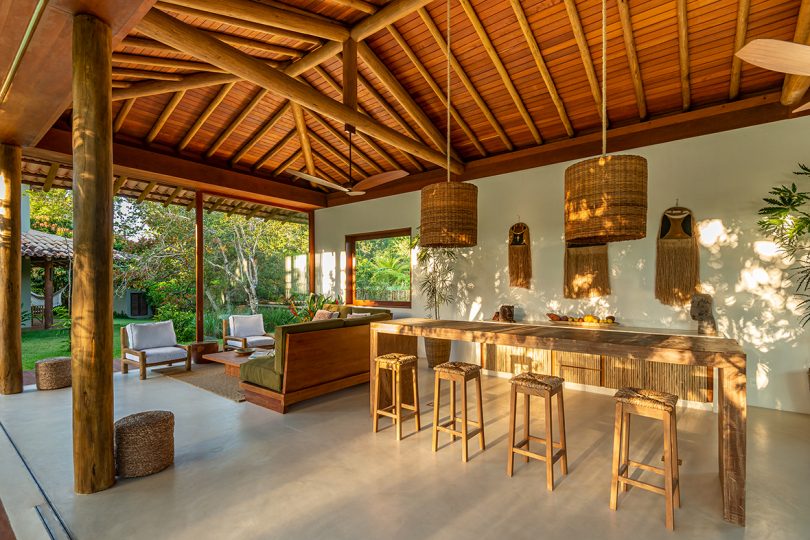 large open concept living space with wooden ceiling, a table with bar stools, and a seating area