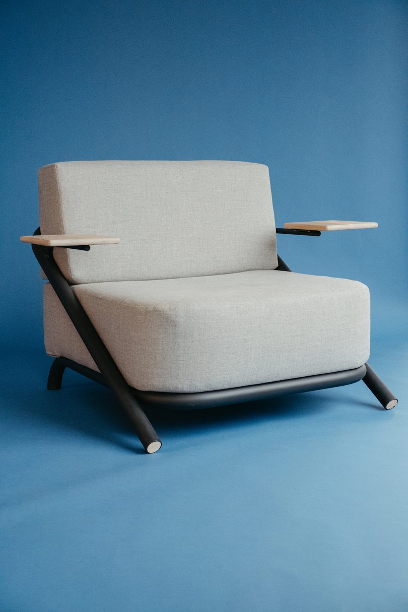 chunky modern armchair against a blue background