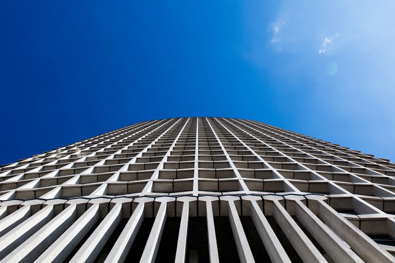 looking up at the facade of a tall building