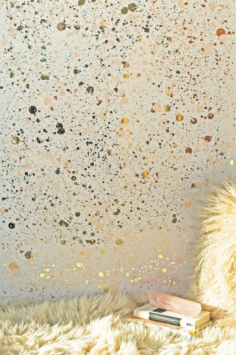interior view of metallic splattered wallpaper in gold tones
