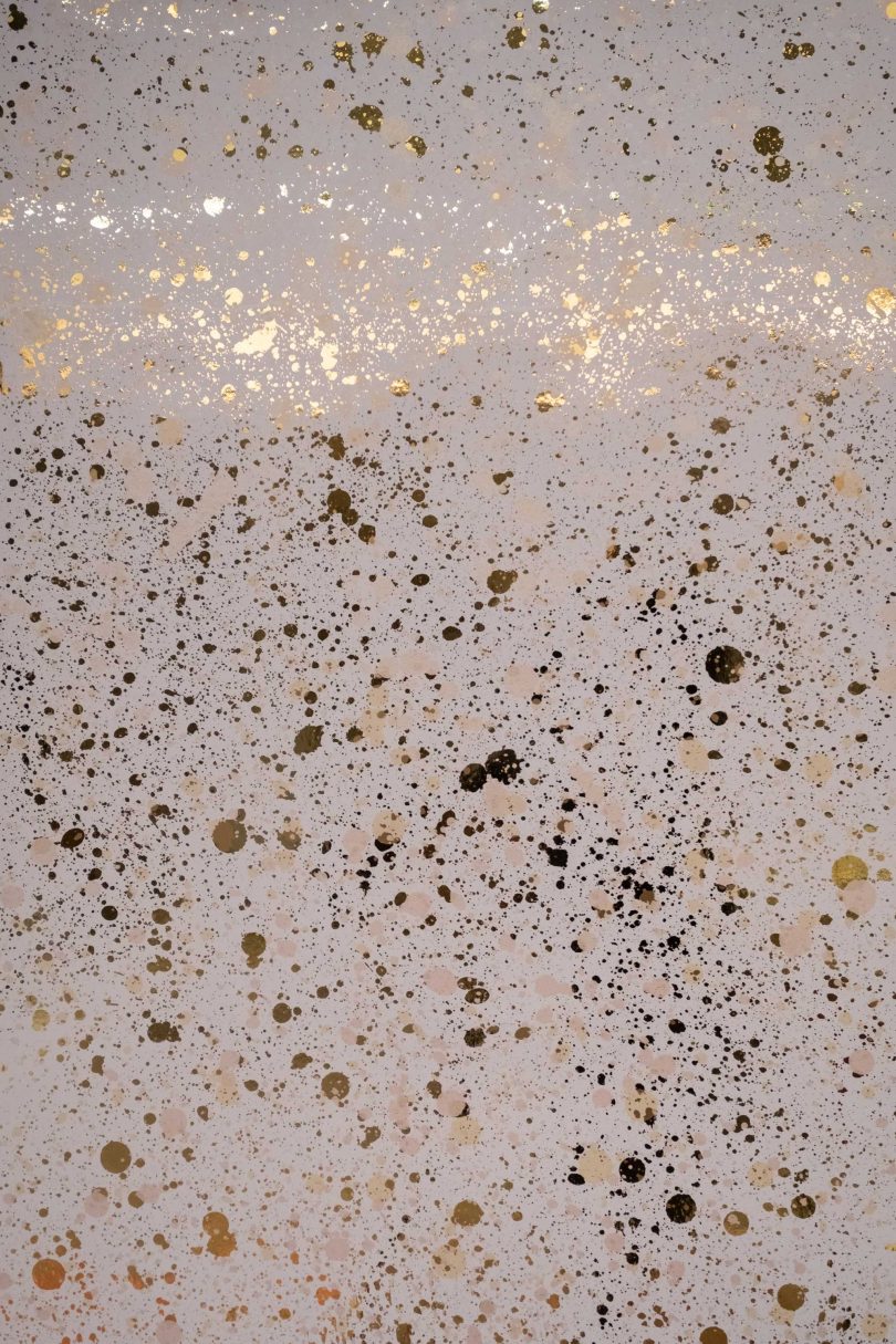 interior view of metallic wallpaper scattered in golden tones