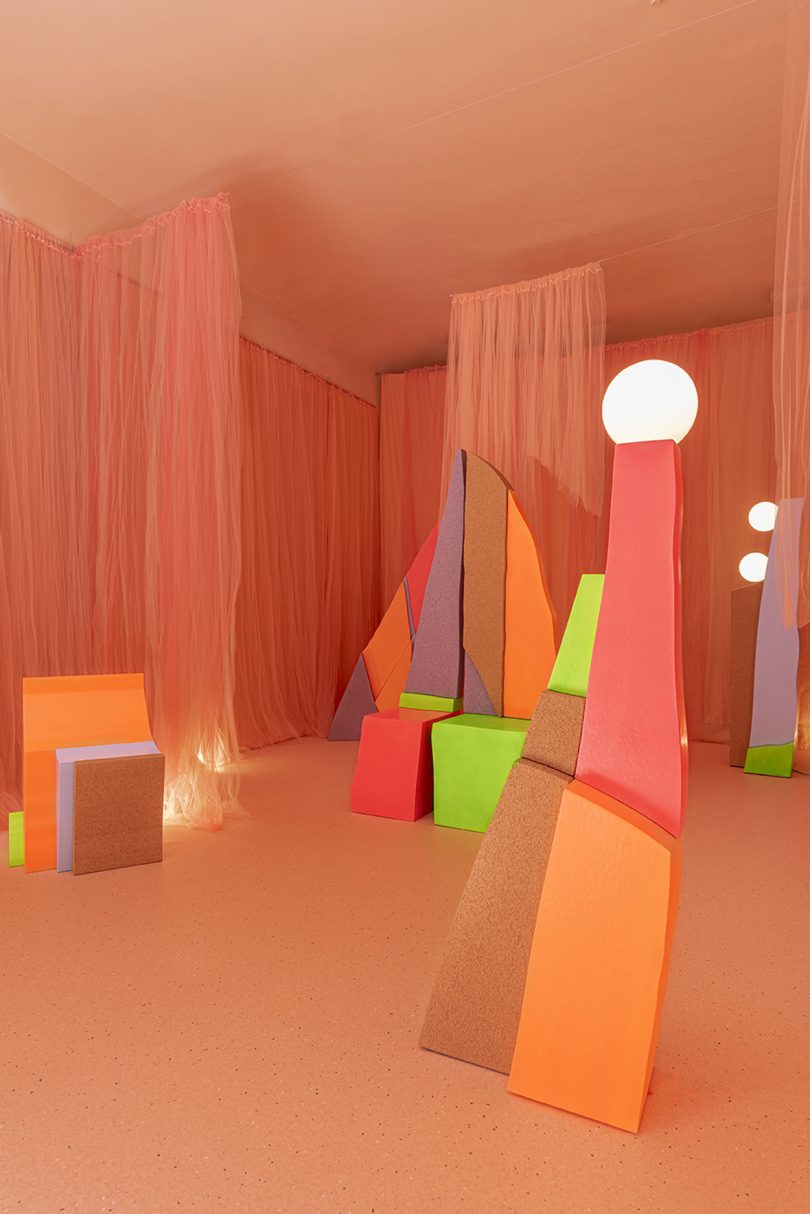 exhibition featuring neon colored forms and textures