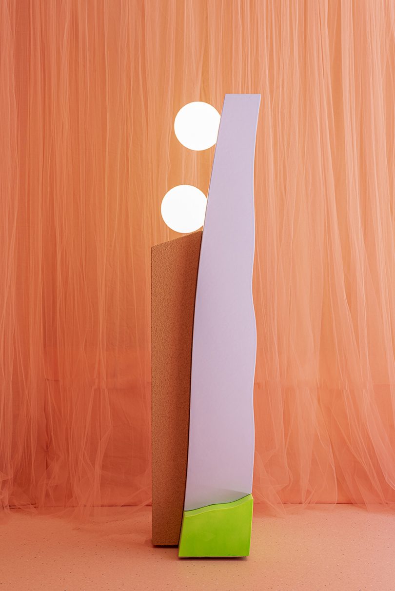 neon colored light form against a peach colored background