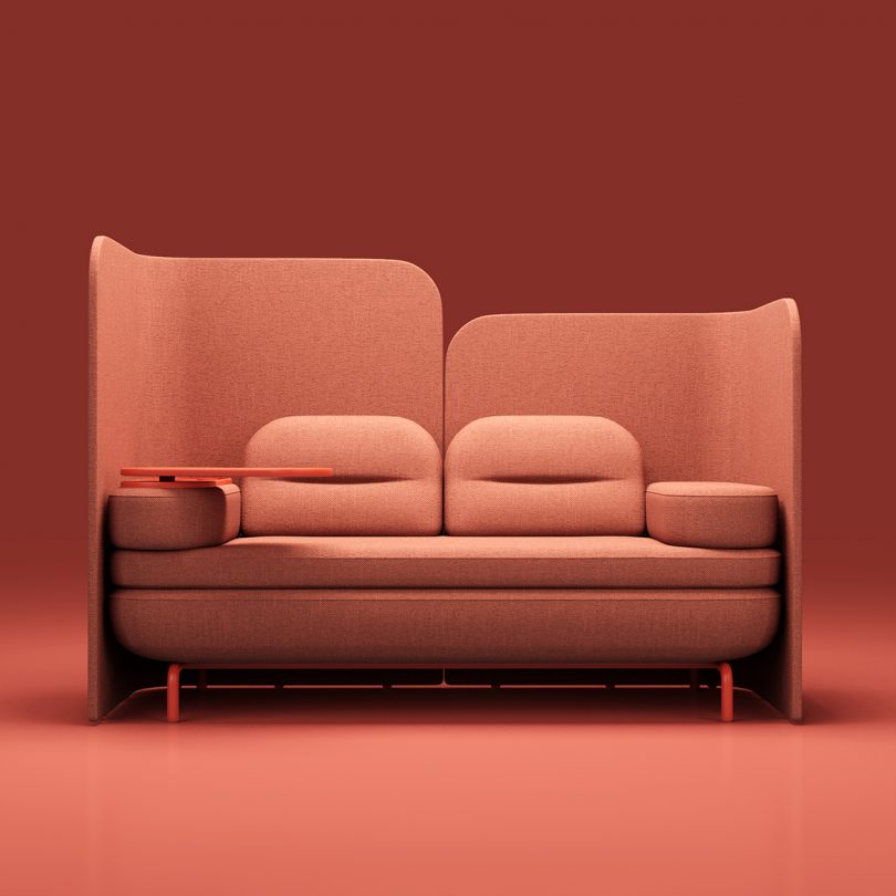 coral colored modular office sofa with space divider against a matching background
