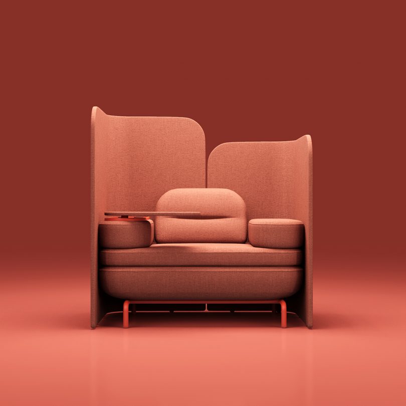 coral colored modular office sofa with space divider against a matching background