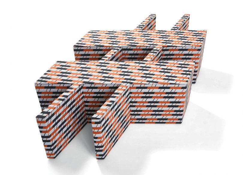 piece of furniture shaped like the pound sign and covered in matching patterned fabric