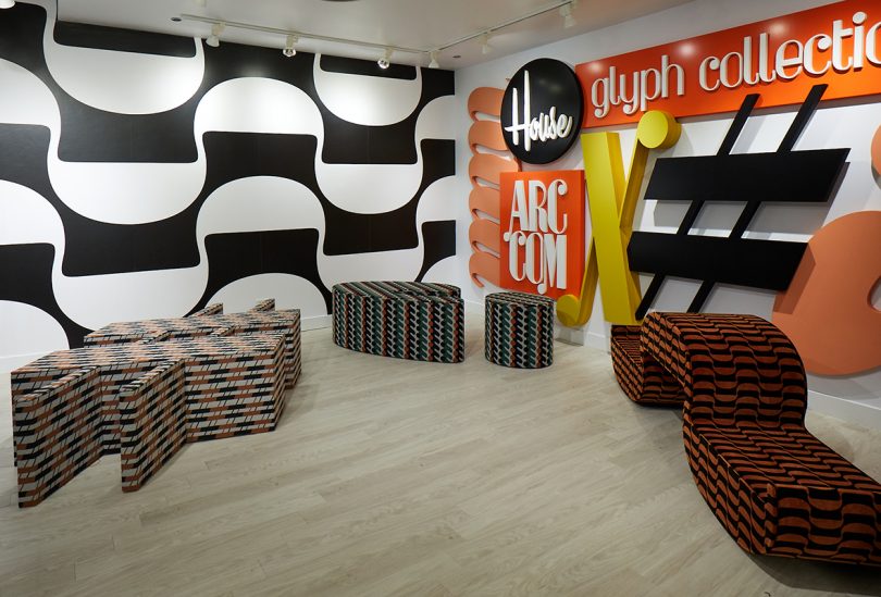 showroom with three pieces of furniture covered in patterned fabric