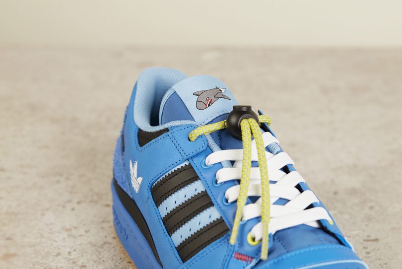 Detail of adidas Forum Low with Rocket character on sneaker tongue.