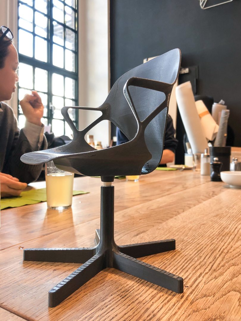 Scale model of the Zeph chair placed on conference table.