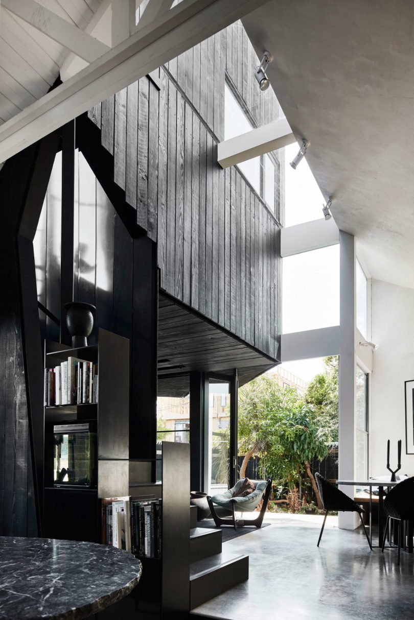 interior view of modern home with high ceilings and a black and white color scheme