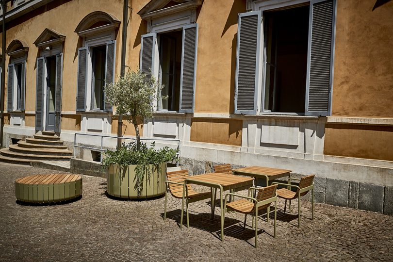 outdoor cafe tables and armchairs in a muted outdoor area