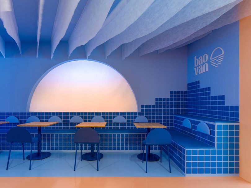 modern restaurant interior in bright blue and peach color scheme