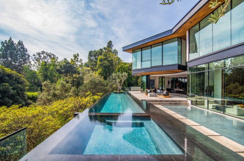 backyard of modern house with side view of elongated swimming pool