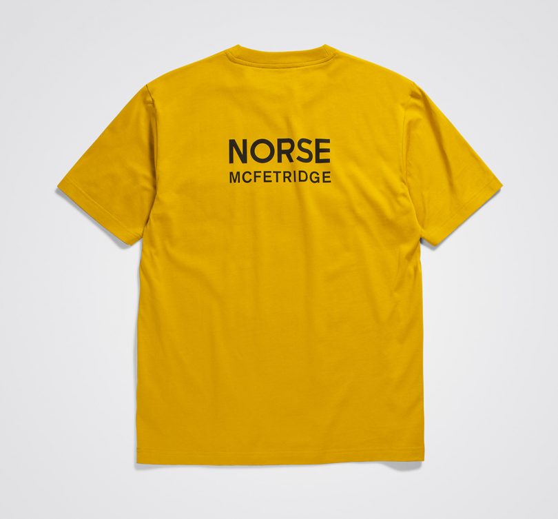 yellow tshirt flat with Norse McFetridge type in black