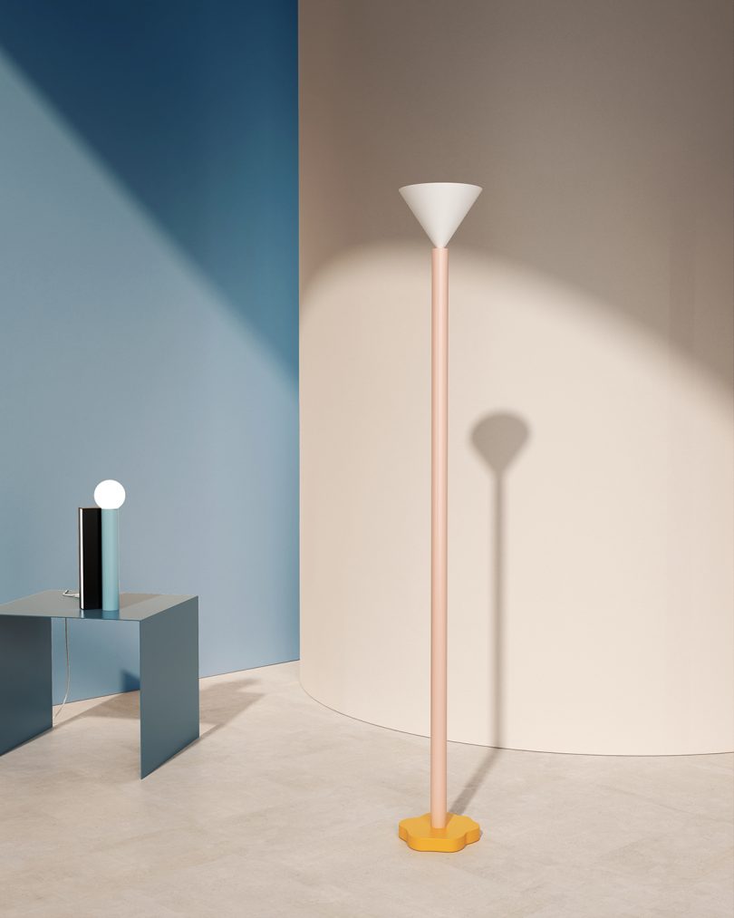 styled space with light blue and white walls, floor lamp, and table lamp on occasional table