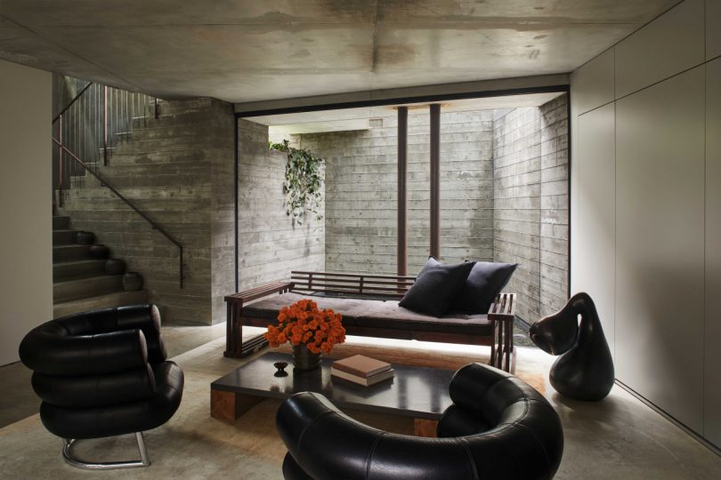 interior of modern, industrial space with concrete walls and dark furnishings